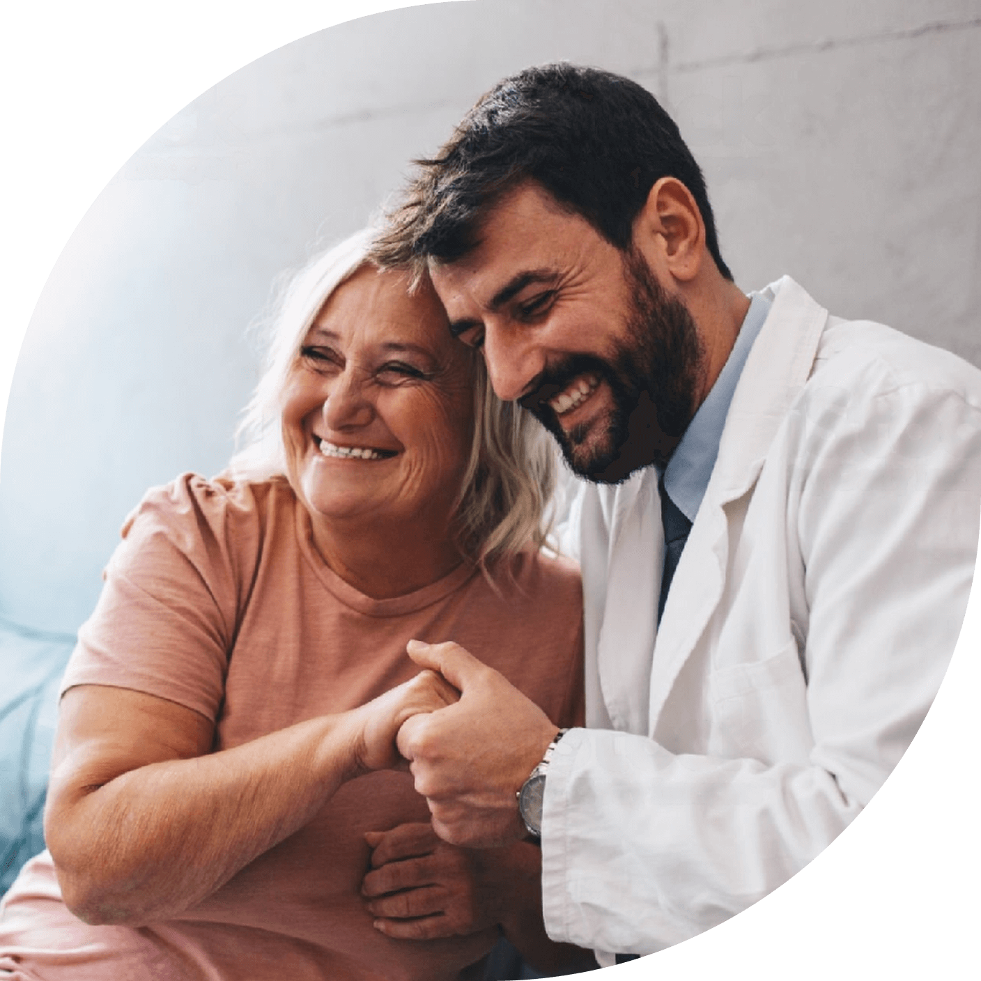 A HCP and patient holding hands and smiling